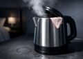Steaming hotel room kettle with lace underwear edge, sparking hygiene outrage.